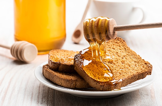 Photo of honey dripping on toast