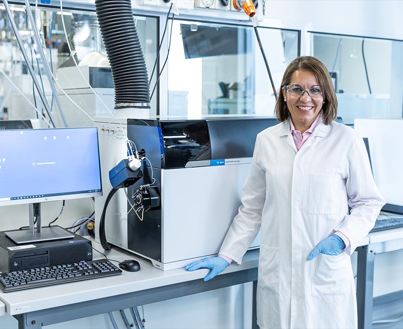 scientist standing next to ICP-QQQ instrument in a lab