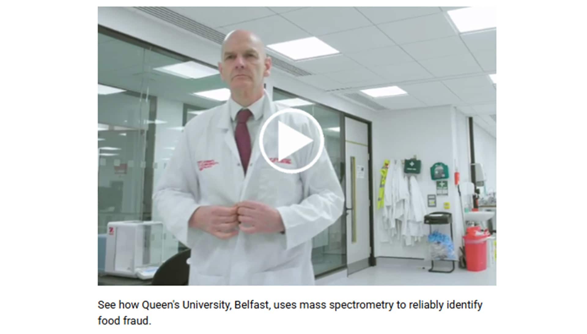Scientist in a lab coat stands confidently in a modern laboratory, illustrating the use of mass spectrometry at Queen’s University Belfast to combat food fraud.