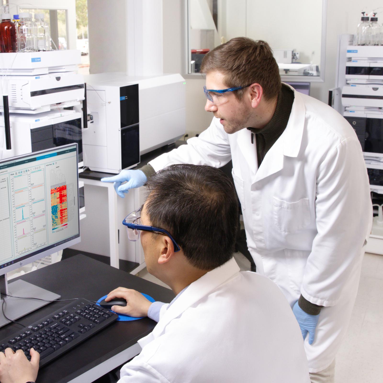 Two scientists using CrossLab software to view data