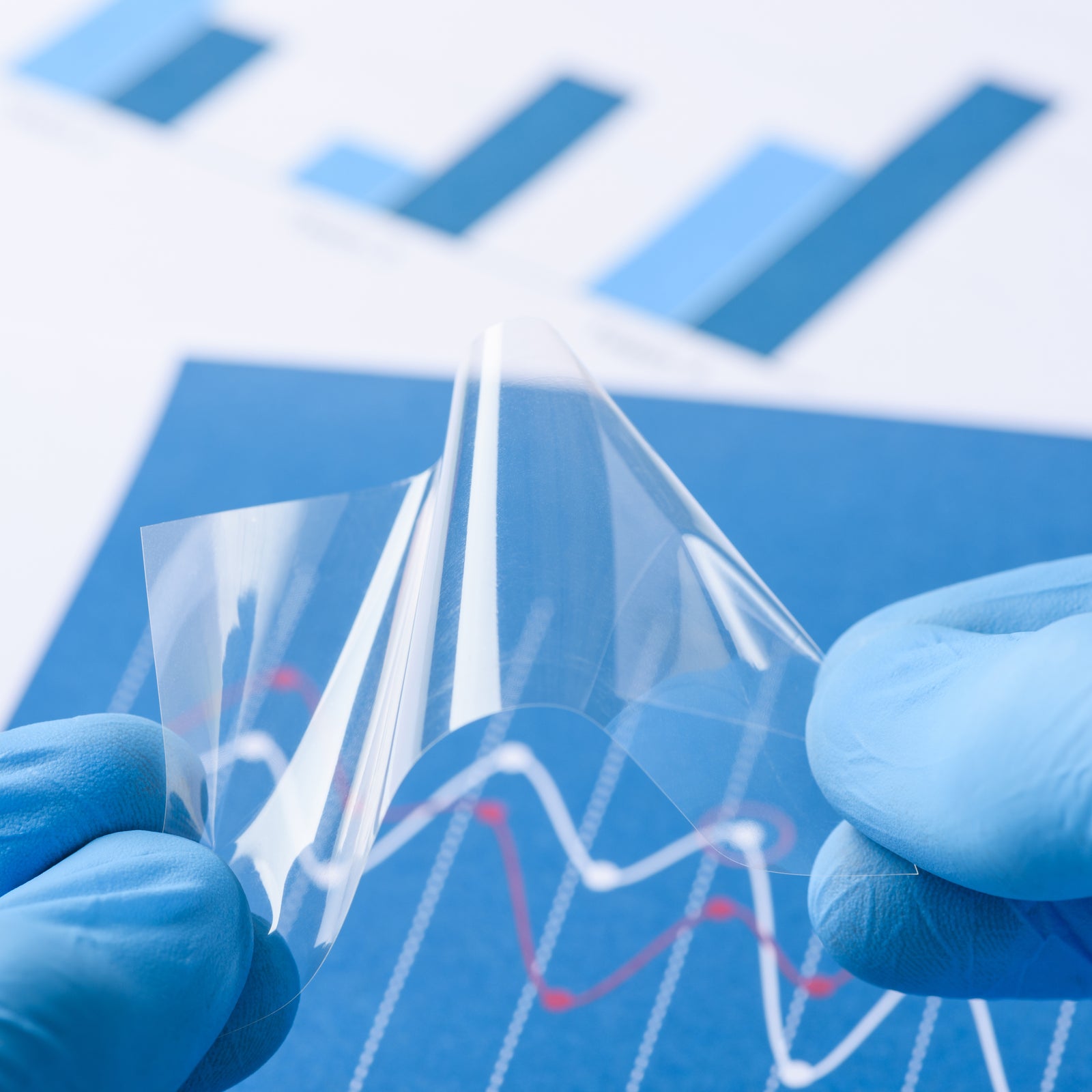 Scientist show novel transparent flexible film material in laboratory
